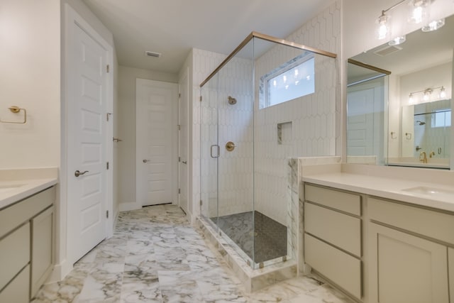 bathroom with a shower with door and vanity