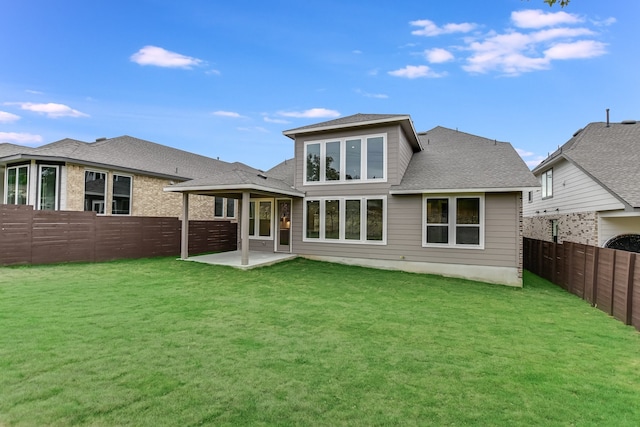 back of house featuring a lawn and a patio