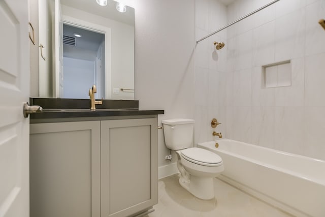 full bathroom featuring toilet, tiled shower / bath combo, tile patterned flooring, and vanity