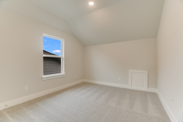 additional living space featuring lofted ceiling and carpet floors