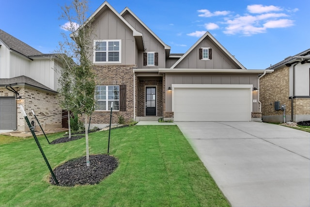 view of front of home with a front yard and a garage