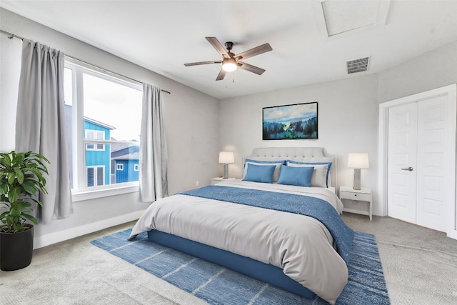 carpeted bedroom featuring ceiling fan and a closet