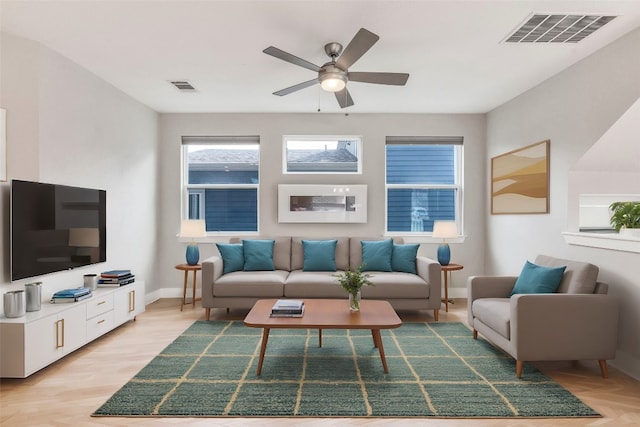 living room featuring ceiling fan and light hardwood / wood-style flooring