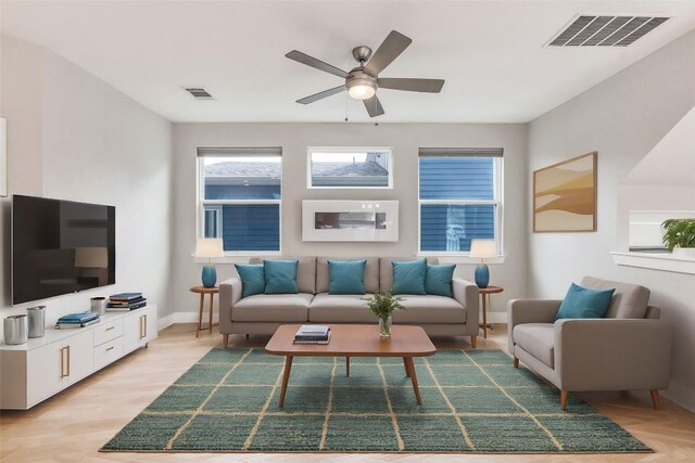 2016 Dinsdale Ln, Austin, TX 78741 - living room with ceiling fan, baseboards, and light wood-type flooring