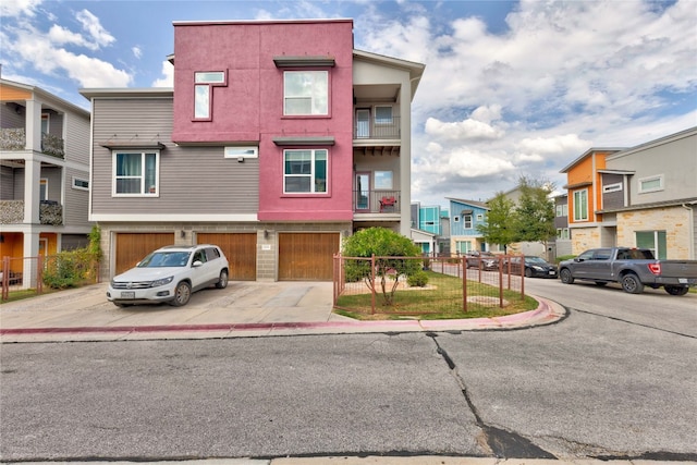 view of front of property featuring a balcony and a garage