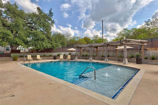 view of pool with a patio, a pergola, and pool water feature