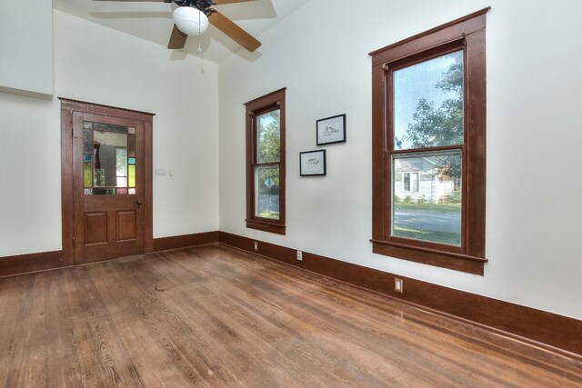 foyer entrance with ceiling fan and wood-type flooring