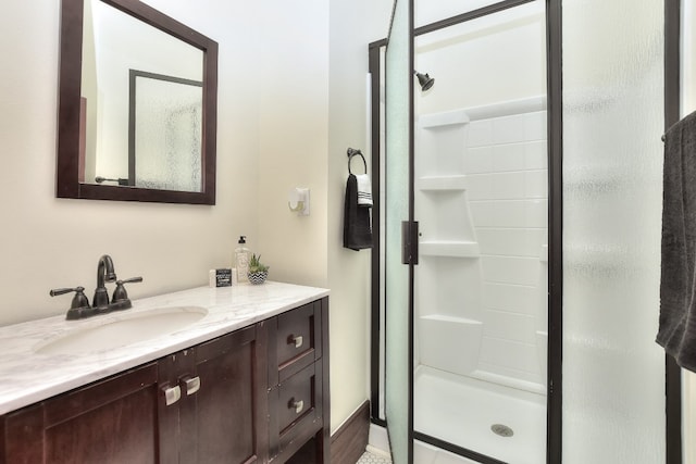 full bathroom featuring a stall shower and vanity