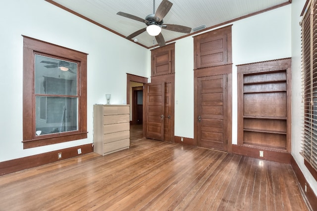 unfurnished bedroom with ceiling fan, hardwood / wood-style flooring, and ornamental molding