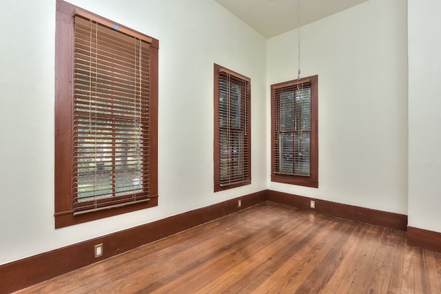 unfurnished room with dark wood-type flooring