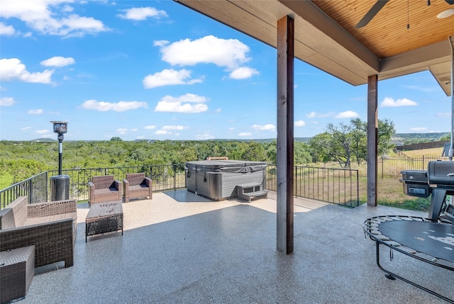 view of patio / terrace featuring grilling area and a hot tub