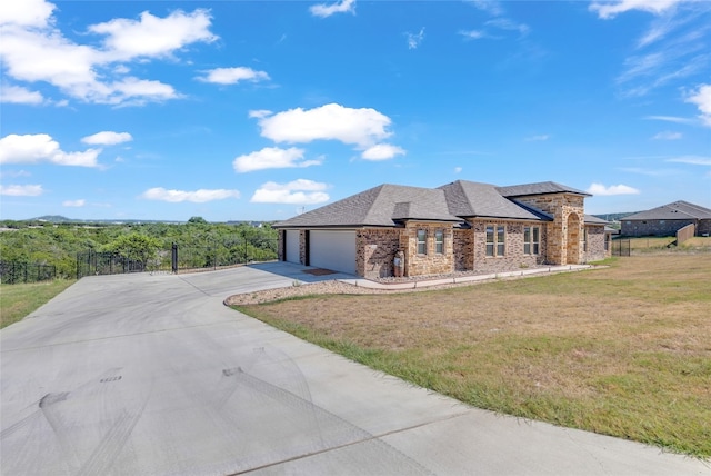 view of front of home with a garage and a front lawn