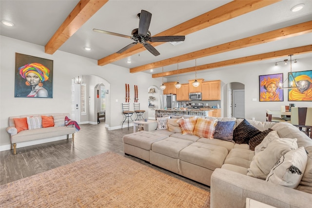 living room with hardwood / wood-style floors, beam ceiling, and ceiling fan