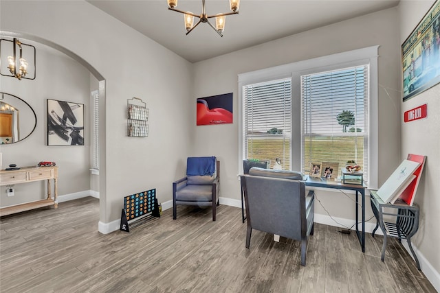 office with an inviting chandelier and hardwood / wood-style floors