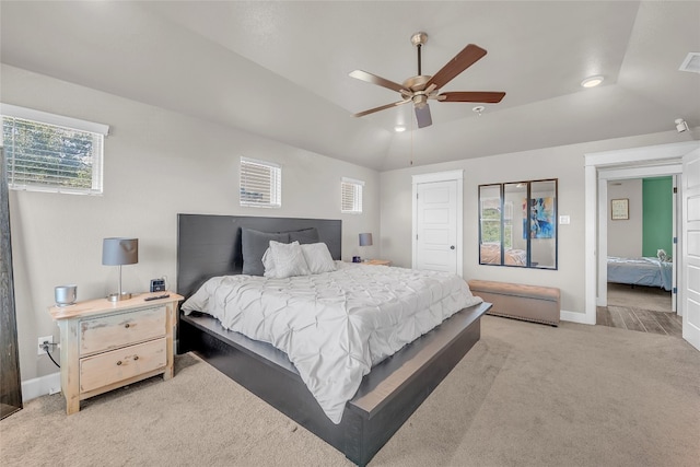 carpeted bedroom featuring lofted ceiling and ceiling fan