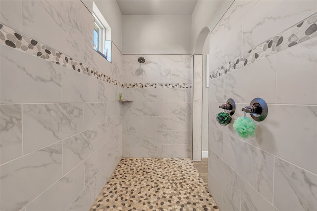 bathroom with a tile shower