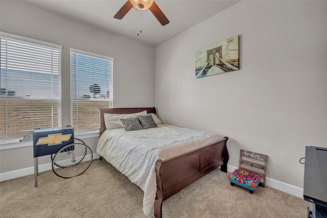 bedroom featuring light colored carpet and ceiling fan