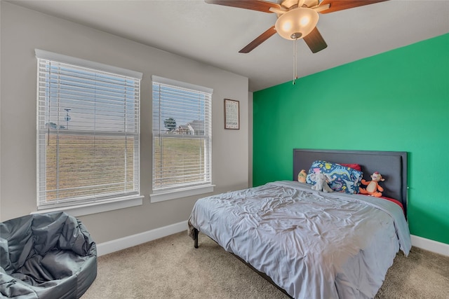 bedroom with ceiling fan and carpet floors