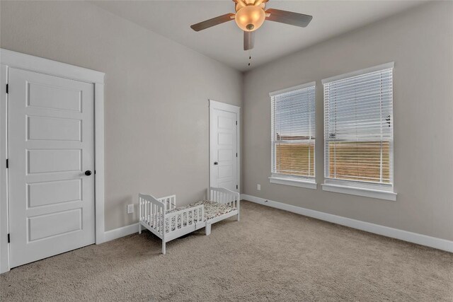 bedroom featuring ceiling fan and light carpet