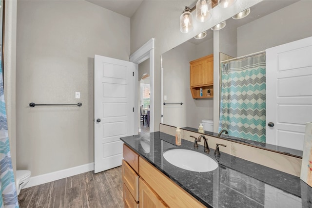 bathroom with vanity, toilet, and hardwood / wood-style floors