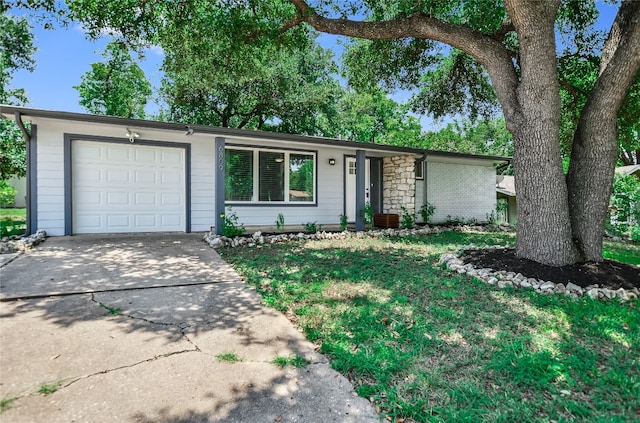 ranch-style home with a garage and a front lawn