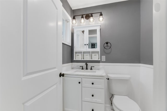 bathroom with toilet and vanity