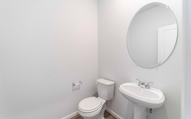 bathroom featuring toilet and sink