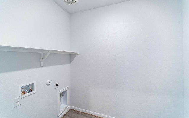 clothes washing area featuring hookup for an electric dryer, hardwood / wood-style flooring, gas dryer hookup, and hookup for a washing machine