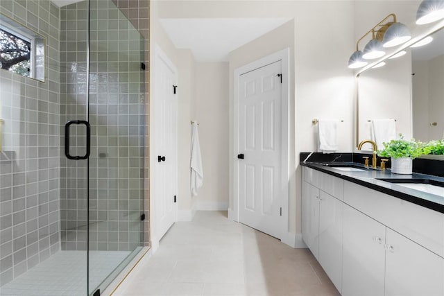 bathroom with tile patterned floors, a shower with door, and vanity