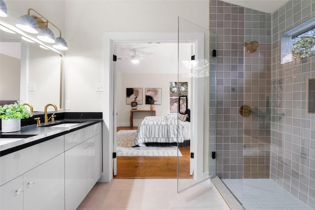 bathroom with hardwood / wood-style flooring, vanity, ceiling fan, and walk in shower