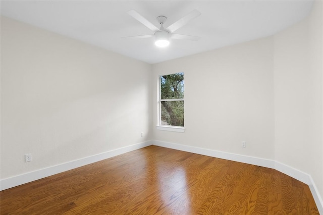 empty room with hardwood / wood-style flooring and ceiling fan