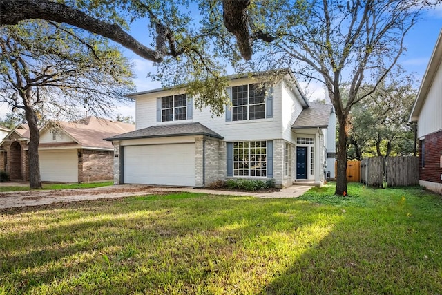 view of property with a garage and a front lawn