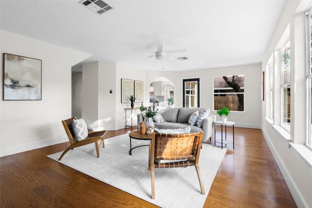 living room with hardwood / wood-style flooring and ceiling fan