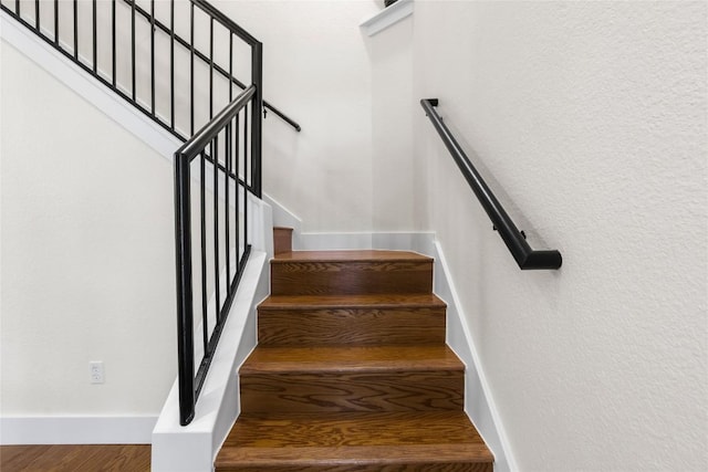 stairway featuring wood-type flooring