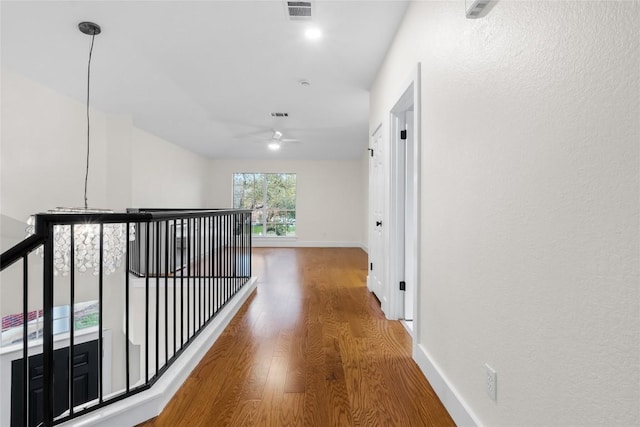 hall with hardwood / wood-style floors