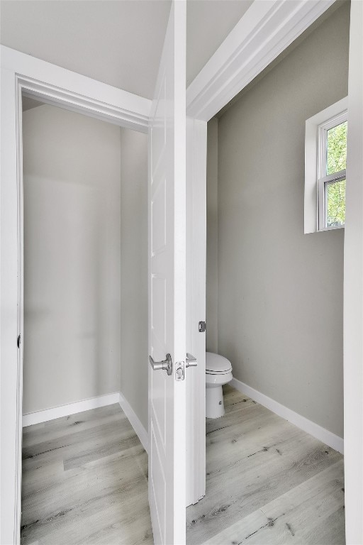 bathroom featuring hardwood / wood-style floors and toilet