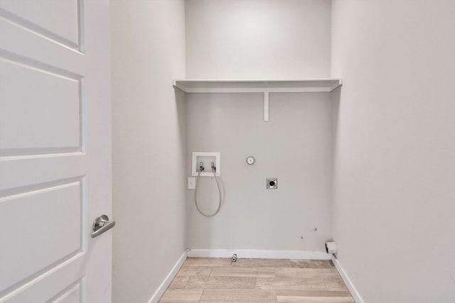 laundry area with washer hookup, hookup for an electric dryer, gas dryer hookup, and light wood-type flooring