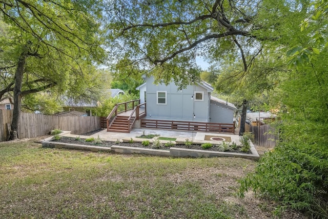 rear view of property featuring a deck