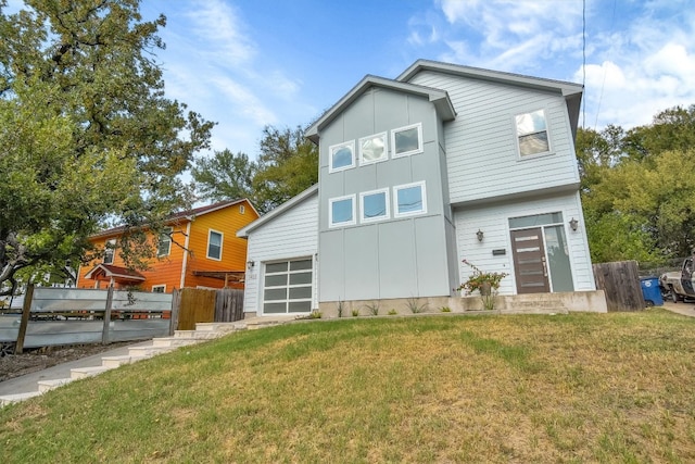 rear view of property featuring a lawn