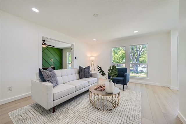 living room featuring ceiling fan and light wood-type flooring