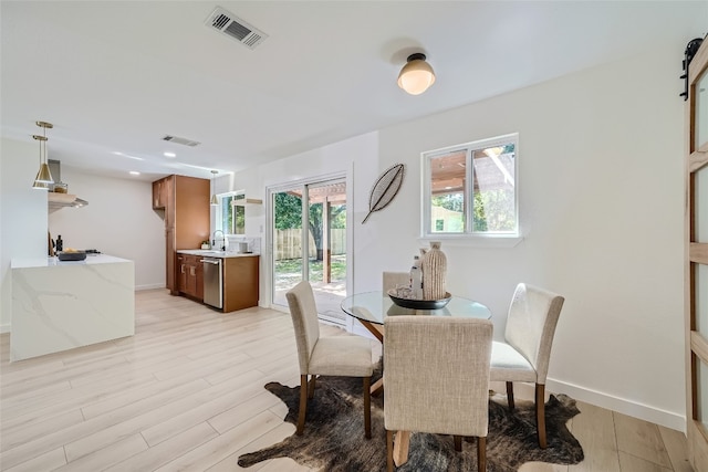 dining space featuring light hardwood / wood-style floors and sink