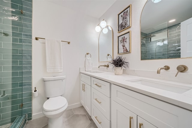 bathroom with tile patterned flooring, vanity, a shower with shower door, and toilet