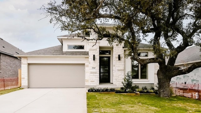 view of front of home featuring a front yard and a garage