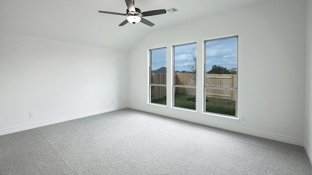 carpeted spare room with vaulted ceiling and ceiling fan