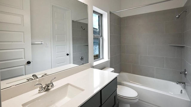 full bathroom featuring plenty of natural light, vanity, tiled shower / bath combo, and toilet