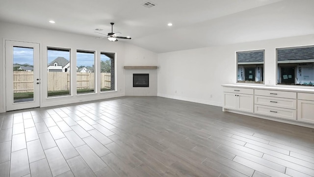 unfurnished living room with ceiling fan and lofted ceiling