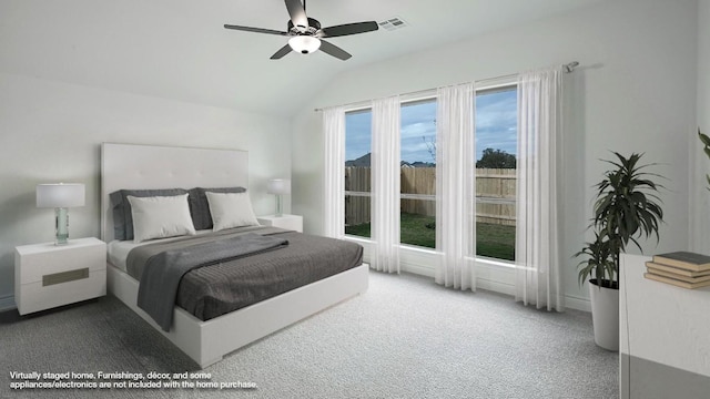 carpeted bedroom featuring ceiling fan and vaulted ceiling