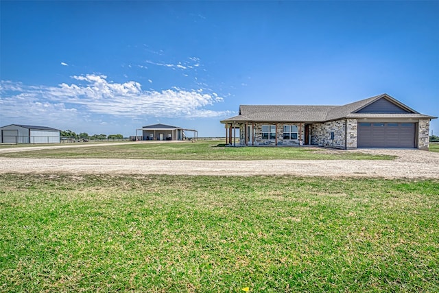 single story home featuring a garage and a front yard