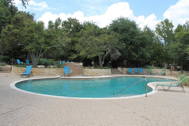 view of swimming pool featuring a patio area