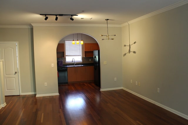 kitchen with dark hardwood / wood-style floors, decorative light fixtures, sink, ornamental molding, and black appliances